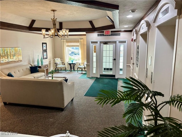1931 King James Unit 131, Westlake, OH 44145 - living area featuring a textured ceiling, a chandelier, and carpet flooring
