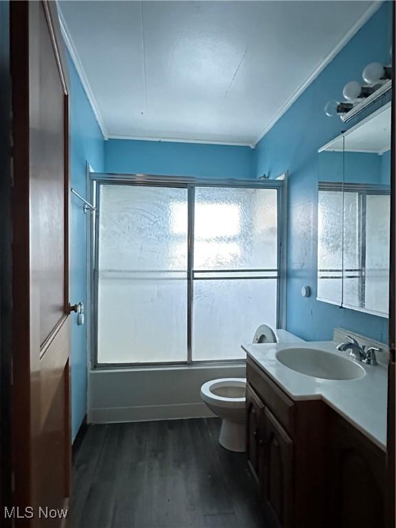 1937 Highlawn Ave, Youngstown, OH 44509 - full bath with shower / bath combination, vanity, wood finished floors, toilet, and ornamental molding