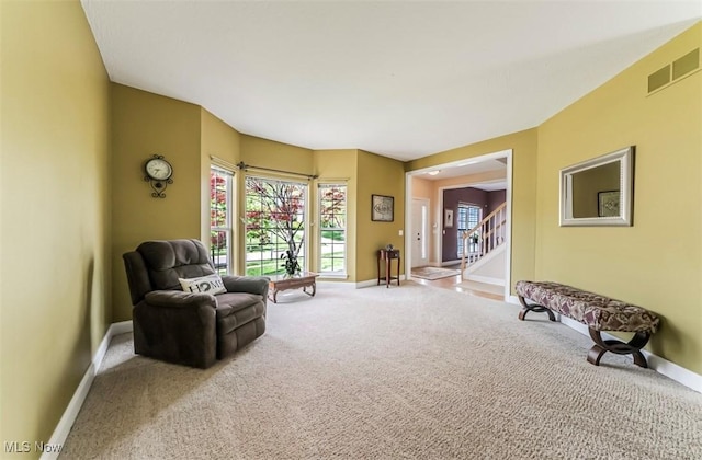 2768 Rising Meadow Dr, Akron, OH 44333 - living area with baseboards, carpet flooring, and stairs