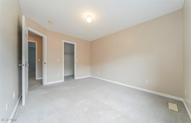 2768 Rising Meadow Dr, Akron, OH 44333 - unfurnished bedroom featuring light colored carpet, baseboards, and a closet