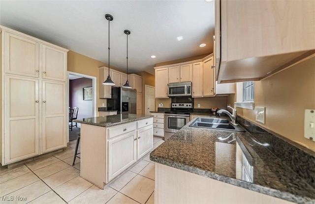 2768 Rising Meadow Dr, Akron, OH 44333 - kitchen featuring appliances with stainless steel finishes, a sink, a center island, pendant lighting, and dark stone counters
