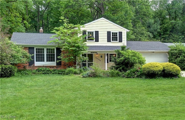 29590 Broxbourne Rd, North Olmsted, OH 44070 - view of front facade featuring an attached garage, a front lawn, and a shingled roof