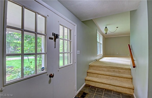 29590 Broxbourne Rd, North Olmsted, OH 44070 - doorway featuring baseboards, stairway, and a textured ceiling