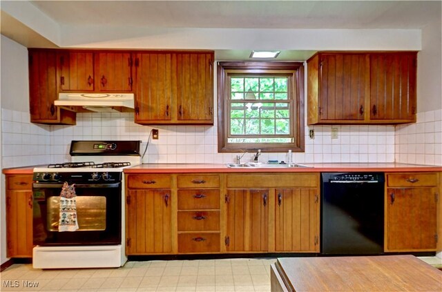 29590 Broxbourne Rd, North Olmsted, OH 44070 - kitchen featuring black dishwasher, range with gas stovetop, under cabinet range hood, a sink, and light countertops