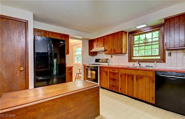 29590 Broxbourne Rd, North Olmsted, OH 44070 - kitchen featuring black appliances, a sink, under cabinet range hood, and healthy amount of natural light