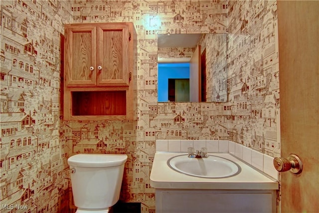 29590 Broxbourne Rd, North Olmsted, OH 44070 - half bath featuring toilet, vanity, and wallpapered walls