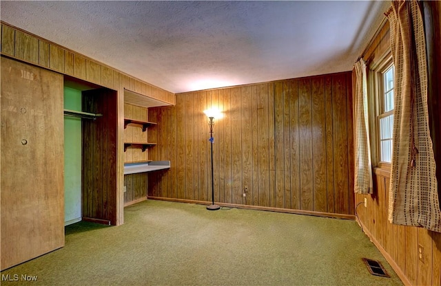 29590 Broxbourne Rd, North Olmsted, OH 44070 - unfurnished bedroom with wood walls, carpet flooring, a textured ceiling, a closet, and baseboards