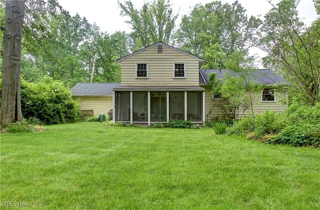 29590 Broxbourne Rd, North Olmsted, OH 44070 - back of house with a sunroom, roof with shingles, and a yard