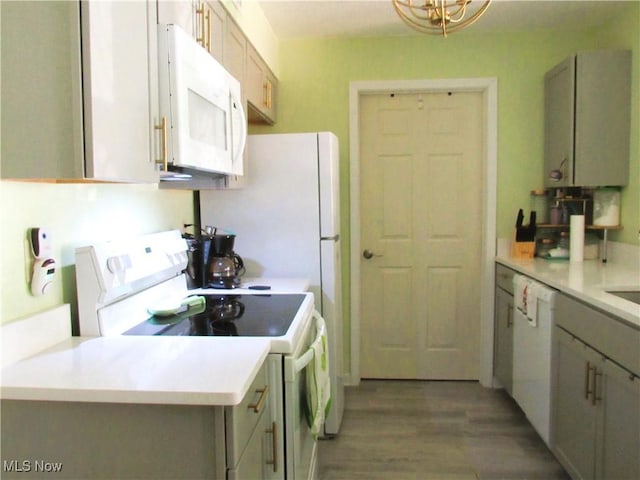 23002 Chandlers Ln Unit 101, Olmsted Falls, OH 44138 - kitchen with white appliances, light wood-style flooring, light countertops, and gray cabinets