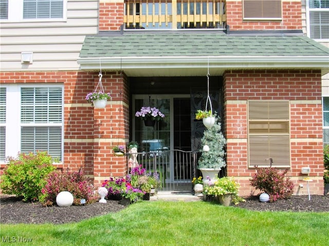 23002 Chandlers Ln Unit 101, Olmsted Falls, OH 44138 - entrance to property with brick siding, a balcony, and a shingled roof