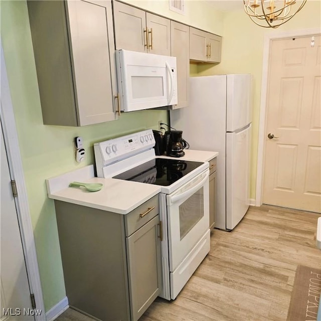 23002 Chandlers Ln Unit 101, Olmsted Falls, OH 44138 - kitchen featuring white appliances, gray cabinetry, light wood finished floors, and light countertops