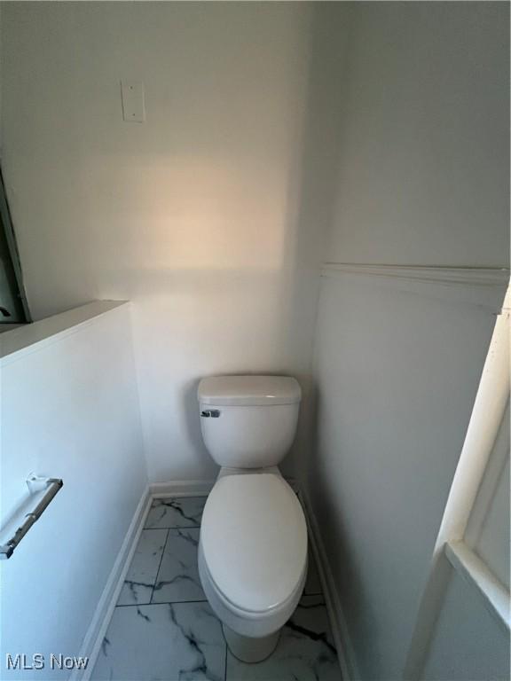 764 Jones St, Hubbard, OH 44425 - bathroom featuring marble finish flooring, toilet, and baseboards