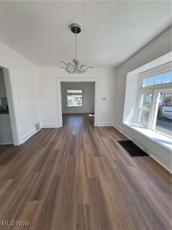 764 Jones St, Hubbard, OH 44425 - unfurnished dining area featuring a chandelier, dark wood finished floors, and baseboards
