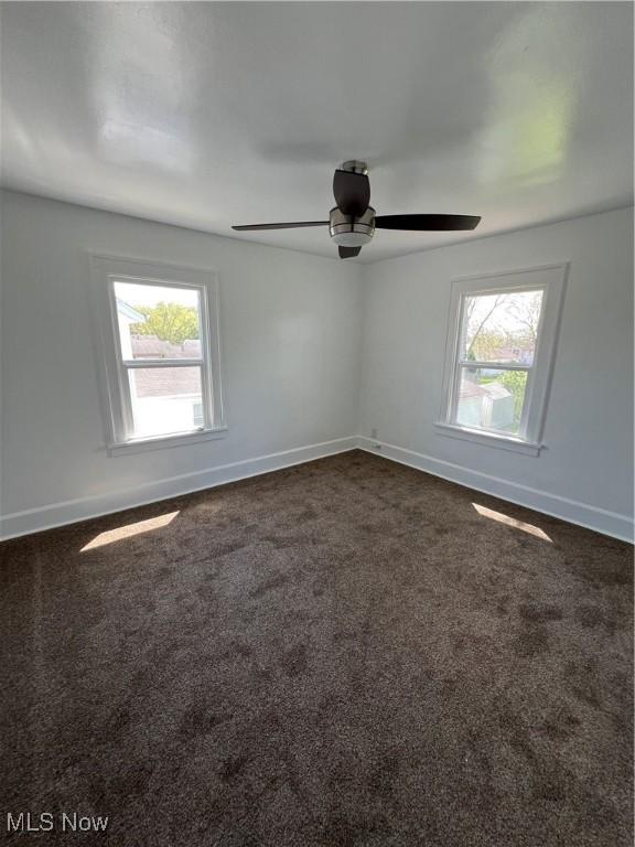 764 Jones St, Hubbard, OH 44425 - unfurnished room with healthy amount of natural light, dark colored carpet, and baseboards