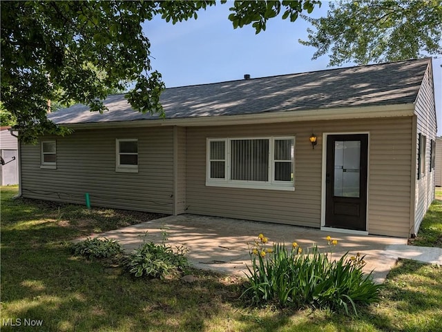 2226 Martha Ave NE, Canton, OH 44705 - rear view of house featuring roof with shingles and a patio area