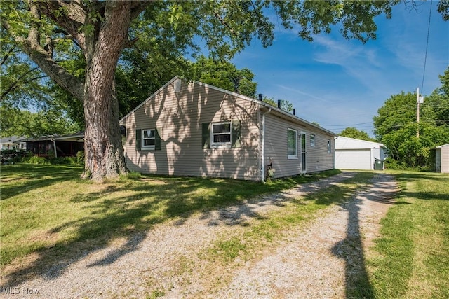 2226 Martha Ave NE, Canton, OH 44705 - view of property exterior featuring a lawn, a detached garage, and an outbuilding
