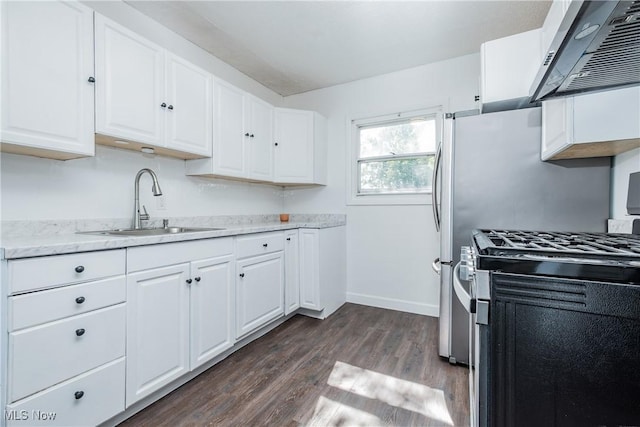 2226 Martha Ave NE, Canton, OH 44705 - kitchen with gas stove, a sink, range hood, dark wood-style floors, and white cabinetry