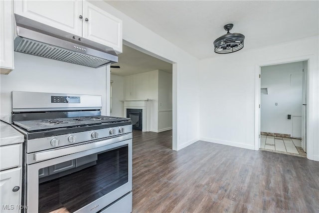 2226 Martha Ave NE, Canton, OH 44705 - kitchen with stainless steel gas range oven, under cabinet range hood, white cabinetry, and wood finished floors