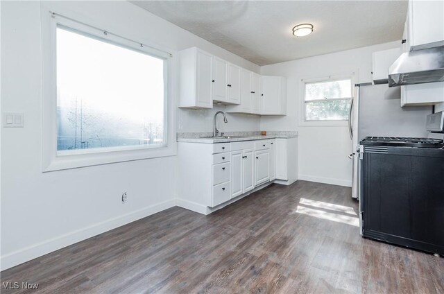2226 Martha Ave NE, Canton, OH 44705 - kitchen featuring range with gas stovetop, extractor fan, a sink, white cabinetry, and light countertops