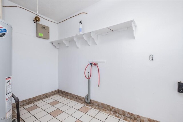 2226 Martha Ave NE, Canton, OH 44705 - laundry area featuring baseboards, light tile patterned flooring, and water heater