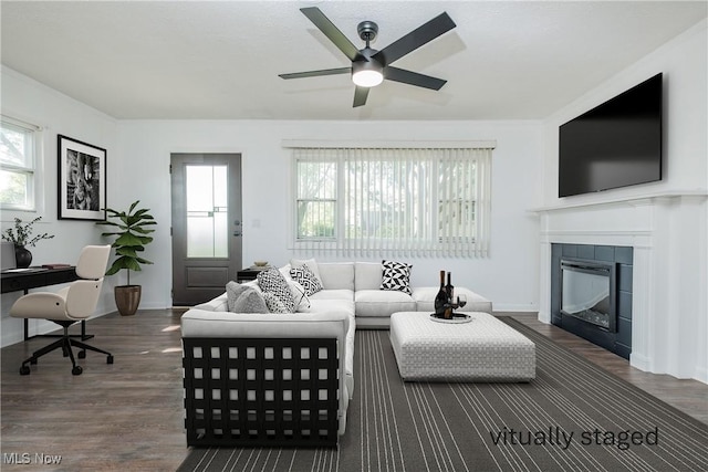2226 Martha Ave NE, Canton, OH 44705 - living area with ceiling fan, wood finished floors, a tiled fireplace, and baseboards