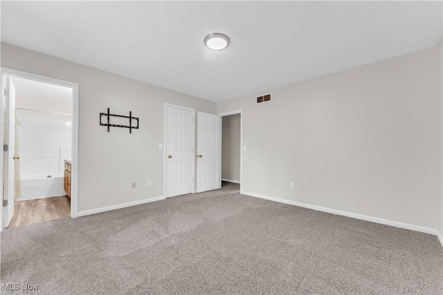 25861 Kennedy Ridge Rd, North Olmsted, OH 44070 - unfurnished bedroom with carpet flooring, baseboards, and ensuite bathroom