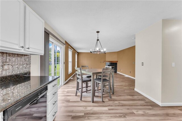 25861 Kennedy Ridge Rd, North Olmsted, OH 44070 - dining area featuring baseboards, a chandelier, and light wood-style flooring