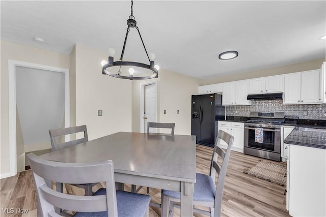 25861 Kennedy Ridge Rd, North Olmsted, OH 44070 - dining area with a chandelier and light wood-style floors