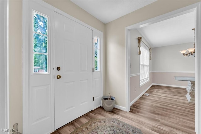 25861 Kennedy Ridge Rd, North Olmsted, OH 44070 - foyer entrance with light wood-style flooring, baseboards, and a chandelier