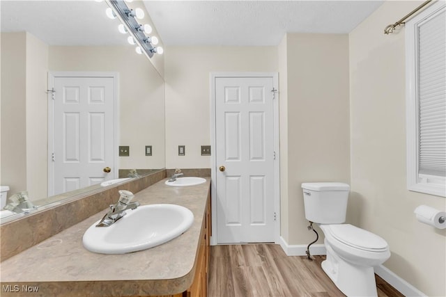 25861 Kennedy Ridge Rd, North Olmsted, OH 44070 - full bath with toilet, double vanity, wood finished floors, and baseboards