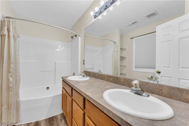 25861 Kennedy Ridge Rd, North Olmsted, OH 44070 - bathroom featuring shower / tub combo with curtain, double vanity, and wood finished floors