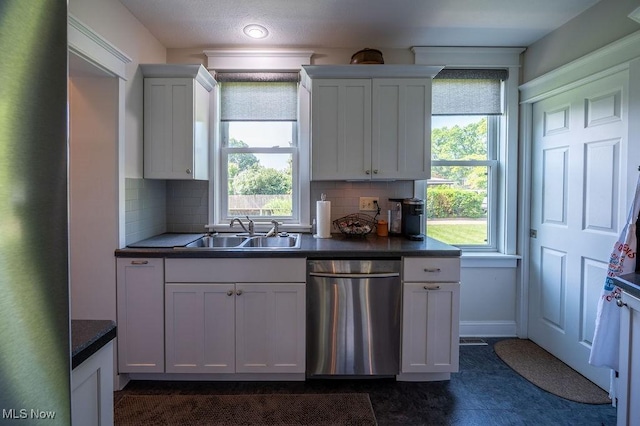 1520 Liberty St, Parkersburg, WV 26101 - kitchen featuring dishwasher, a sink, backsplash, and dark countertops