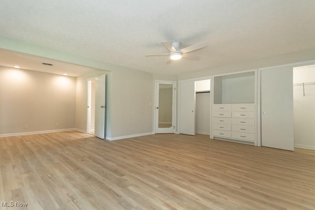 26 Middleton Dr, Painesville Township, OH 44077 - unfurnished bedroom featuring two closets, light wood finished floors, baseboards, and a ceiling fan
