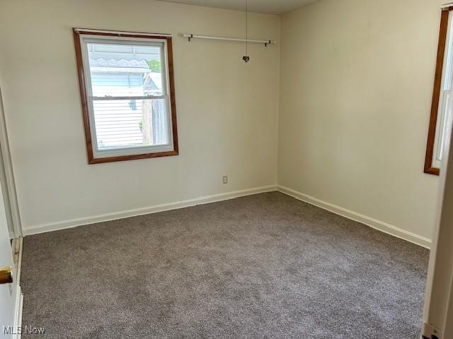 500 Grosvenor Dr NW, Massillon, OH 44647 - spare room featuring carpet flooring and baseboards