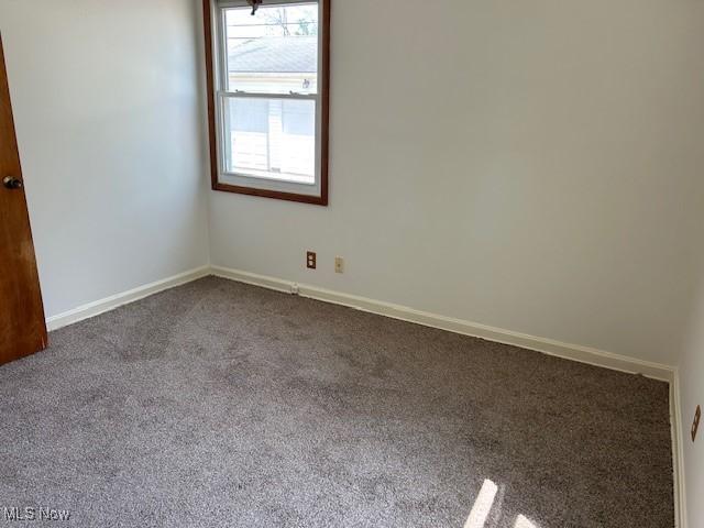 500 Grosvenor Dr NW, Massillon, OH 44647 - unfurnished room featuring dark carpet and baseboards