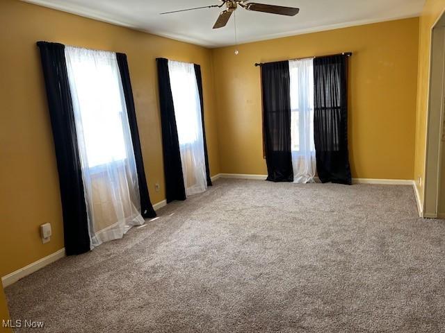 500 Grosvenor Dr NW, Massillon, OH 44647 - carpeted empty room with a ceiling fan and baseboards