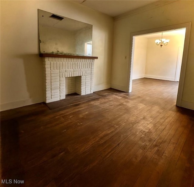 1097 Jefferson St, Follansbee, WV 26037 - unfurnished living room with dark wood finished floors, a chandelier, a brick fireplace, and baseboards