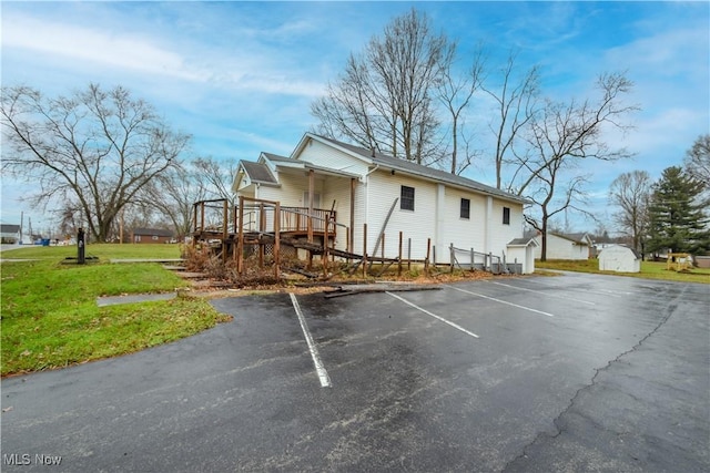 1187 Deforest Rd SE, Warren, OH 44484 - view of home's exterior featuring uncovered parking, a deck, and a yard