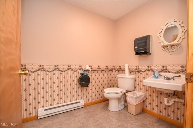 1187 Deforest Rd SE, Warren, OH 44484 - bathroom with a baseboard radiator, toilet, a wainscoted wall, baseboards, and a sink