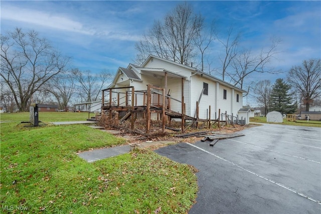 1187 Deforest Rd SE, Warren, OH 44484 - view of home's exterior featuring a lawn, asphalt driveway, and stairway