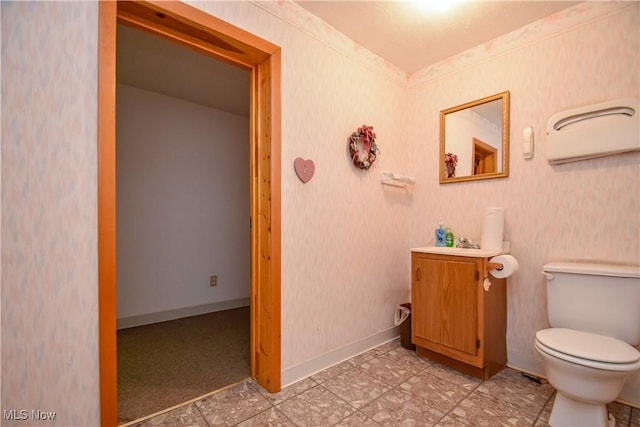 1187 Deforest Rd SE, Warren, OH 44484 - bathroom featuring vanity, toilet, and baseboards