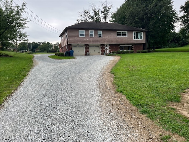 988 E Turkeyfoot Lake Rd, Green, OH 44312 - view of front facade with driveway, a garage, a front lawn, and brick siding