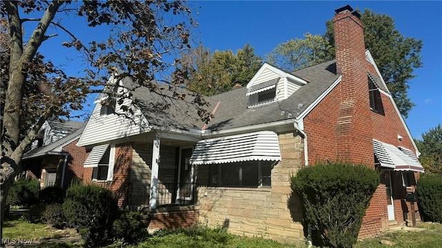341 E 272nd St, Euclid, OH 44132 - view of front facade with a chimney, brick siding, and a shingled roof