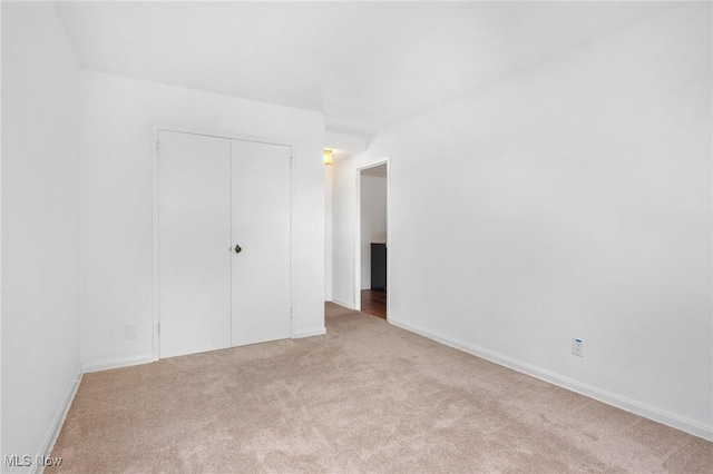 19101 Van Aken Blvd Unit 218, Shaker Heights, OH 44122 - unfurnished bedroom featuring carpet flooring, a closet, and baseboards