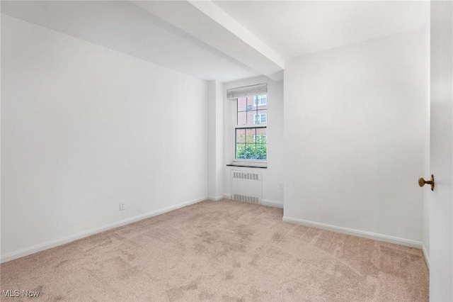 19101 Van Aken Blvd Unit 218, Shaker Heights, OH 44122 - empty room with radiator heating unit, light carpet, and baseboards
