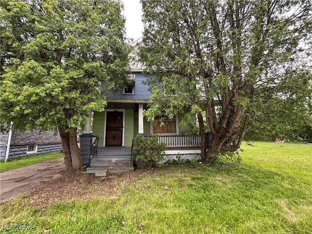 11226 Greenwich Ave, Cleveland, OH 44105 - view of property hidden behind natural elements featuring a porch and a front yard