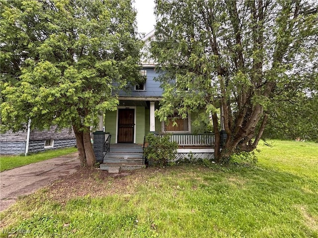 11226 Greenwich Ave, Cleveland, OH 44105 - view of property hidden behind natural elements with covered porch and a front lawn
