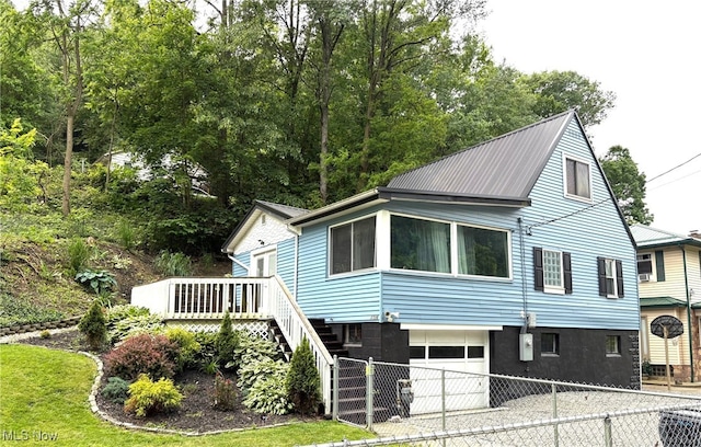 1720 Blosser Ln, Follansbee, WV 26037 - view of side of property with an attached garage, concrete driveway, stairs, metal roof, and a wooden deck