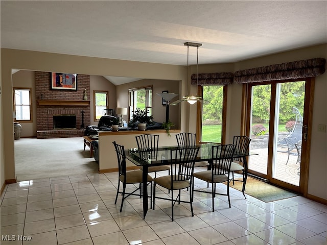 12701 Gordon St, North Royalton, OH 44133 - dining area featuring healthy amount of natural light, light tile patterned floors, and a fireplace