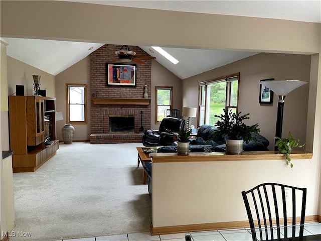 12701 Gordon St, North Royalton, OH 44133 - living room featuring healthy amount of natural light, vaulted ceiling, a brick fireplace, and carpet